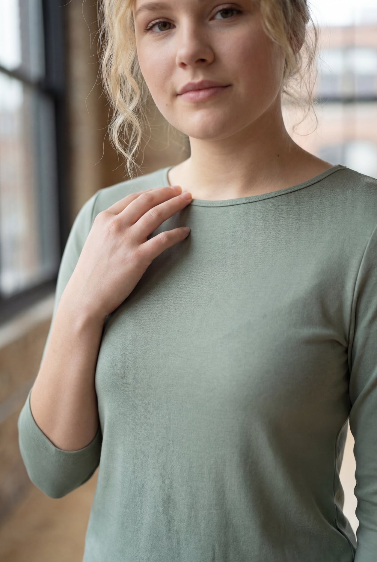 Model wearing the Nuggles® Essential 3/4 Tee in seafoam green