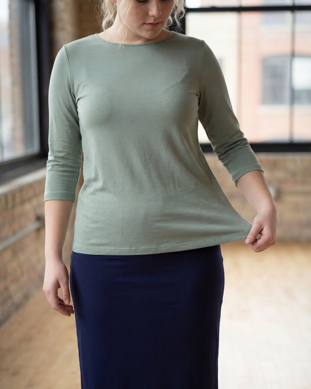 Model wearing the Nuggles® Essential 3/4 Tee in seafoam green