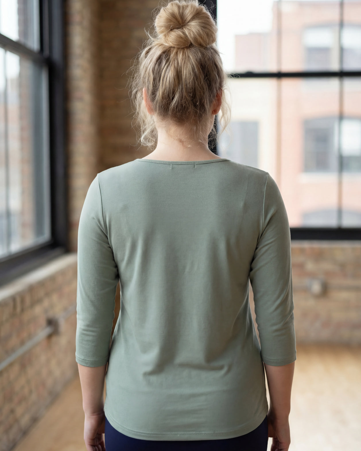 Model wearing the Nuggles® Essential 3/4 Tee in seafoam green
