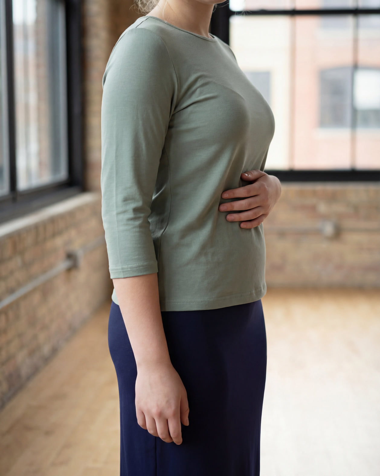 Model wearing the Nuggles® Essential 3/4 Tee in seafoam green