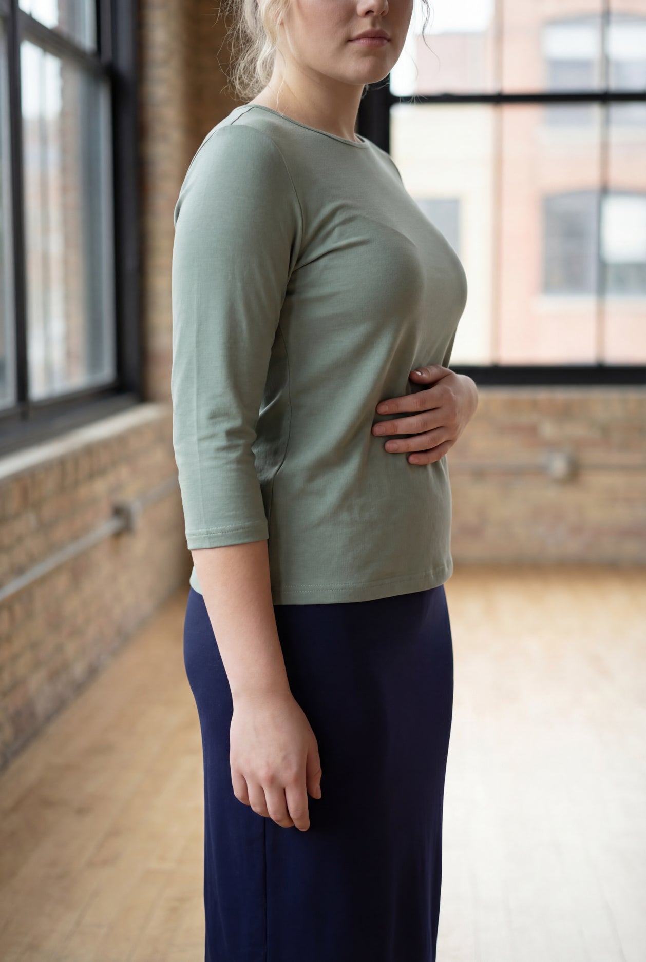 Model wearing the Nuggles® Essential 3/4 Tee in seafoam green