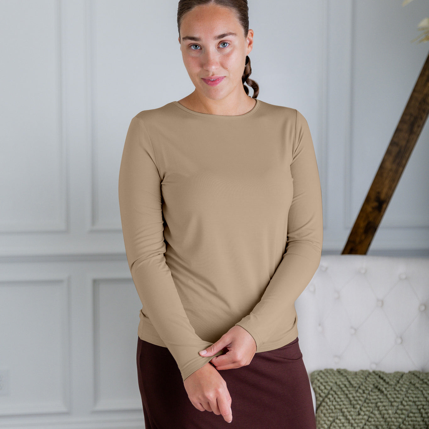 Model styling a neutral Nuggles® long sleeve top for casual everyday outfit inspiration.
