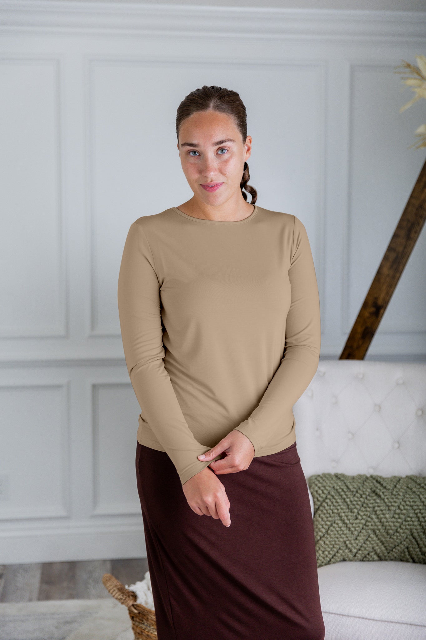 Model styling a neutral Nuggles® long sleeve top for casual everyday outfit inspiration.