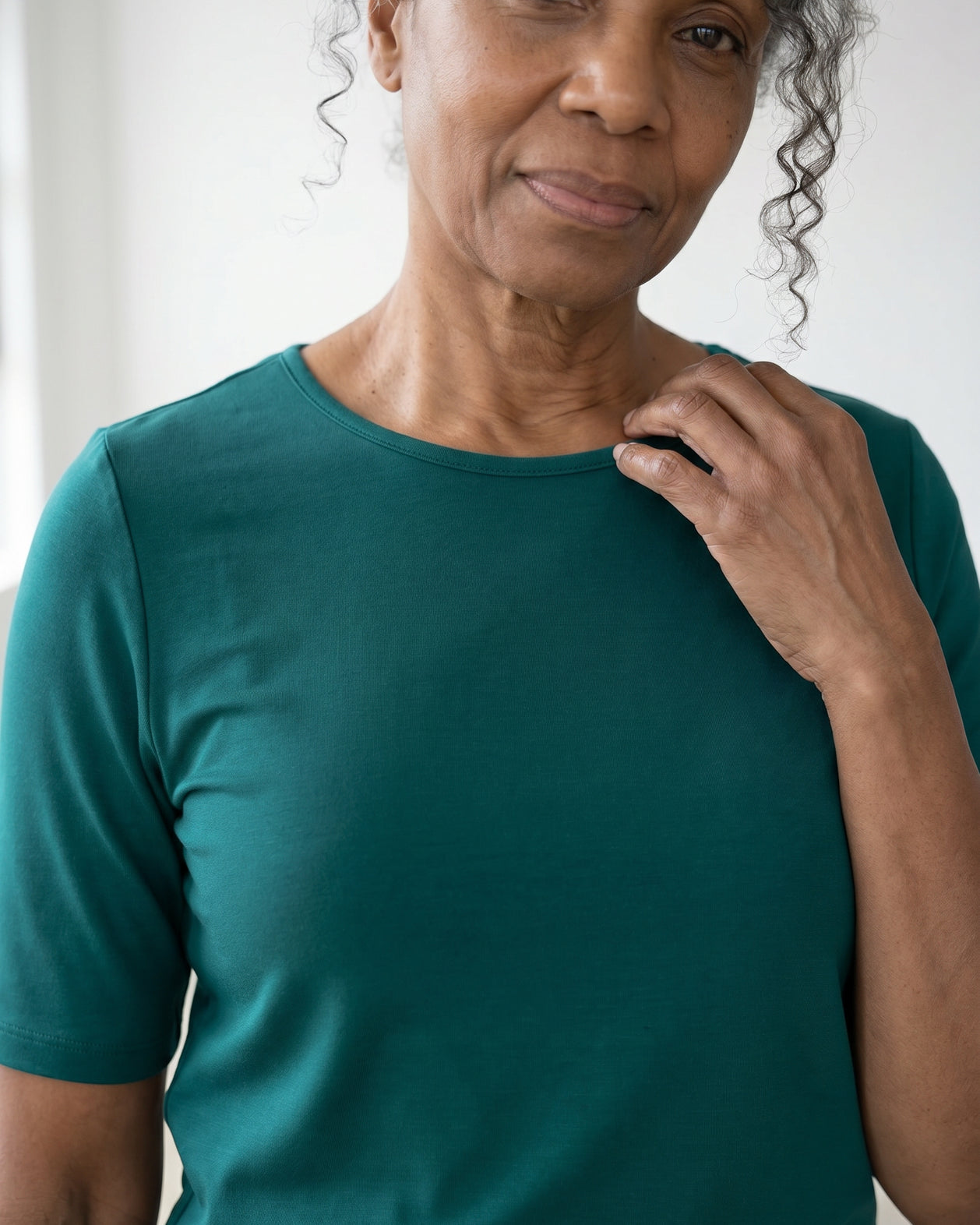 Model wearing Nuggles® Half Sleeve Essential Tee in Teal Green