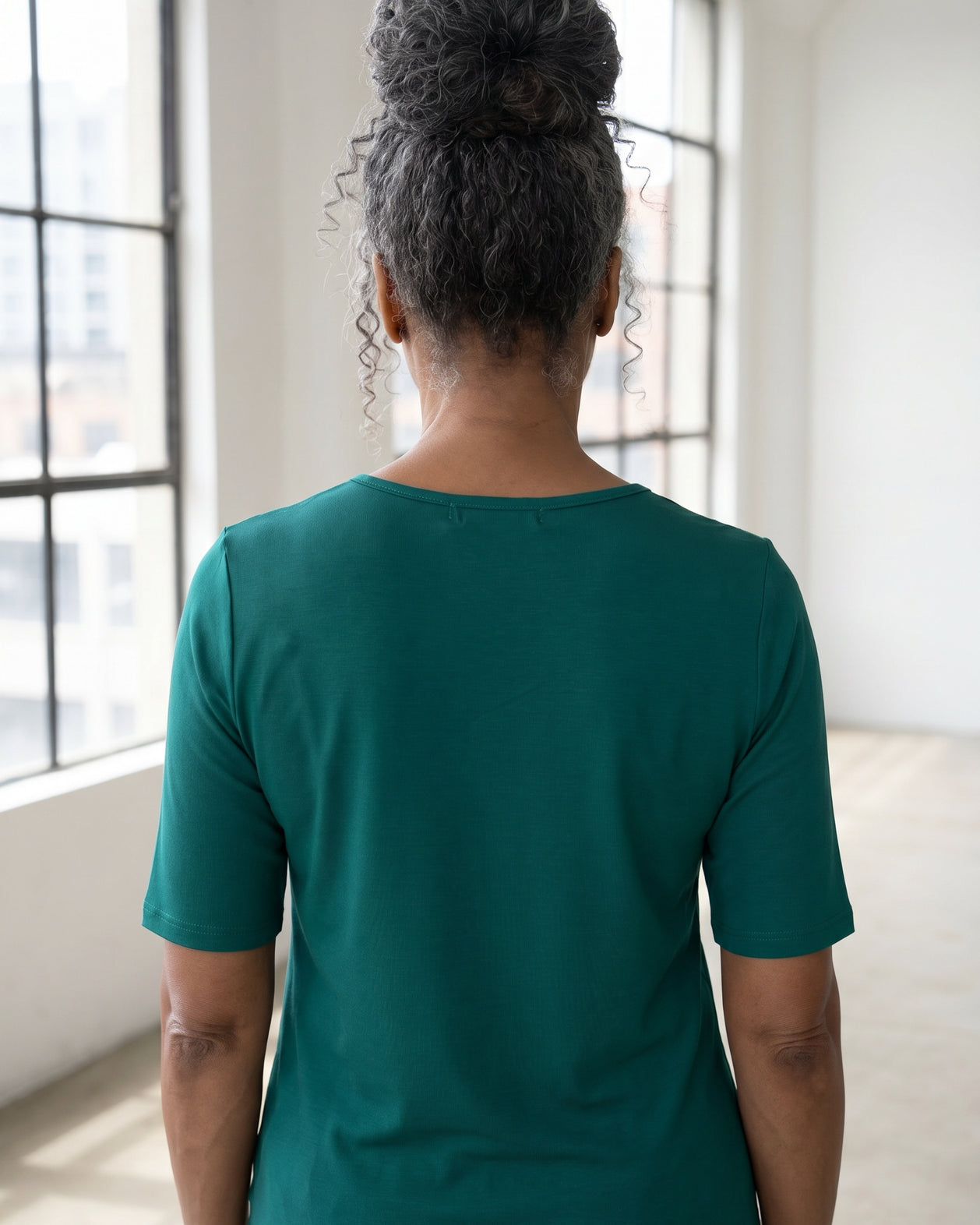 Model wearing Nuggles® Half Sleeve Essential Tee in Teal Green