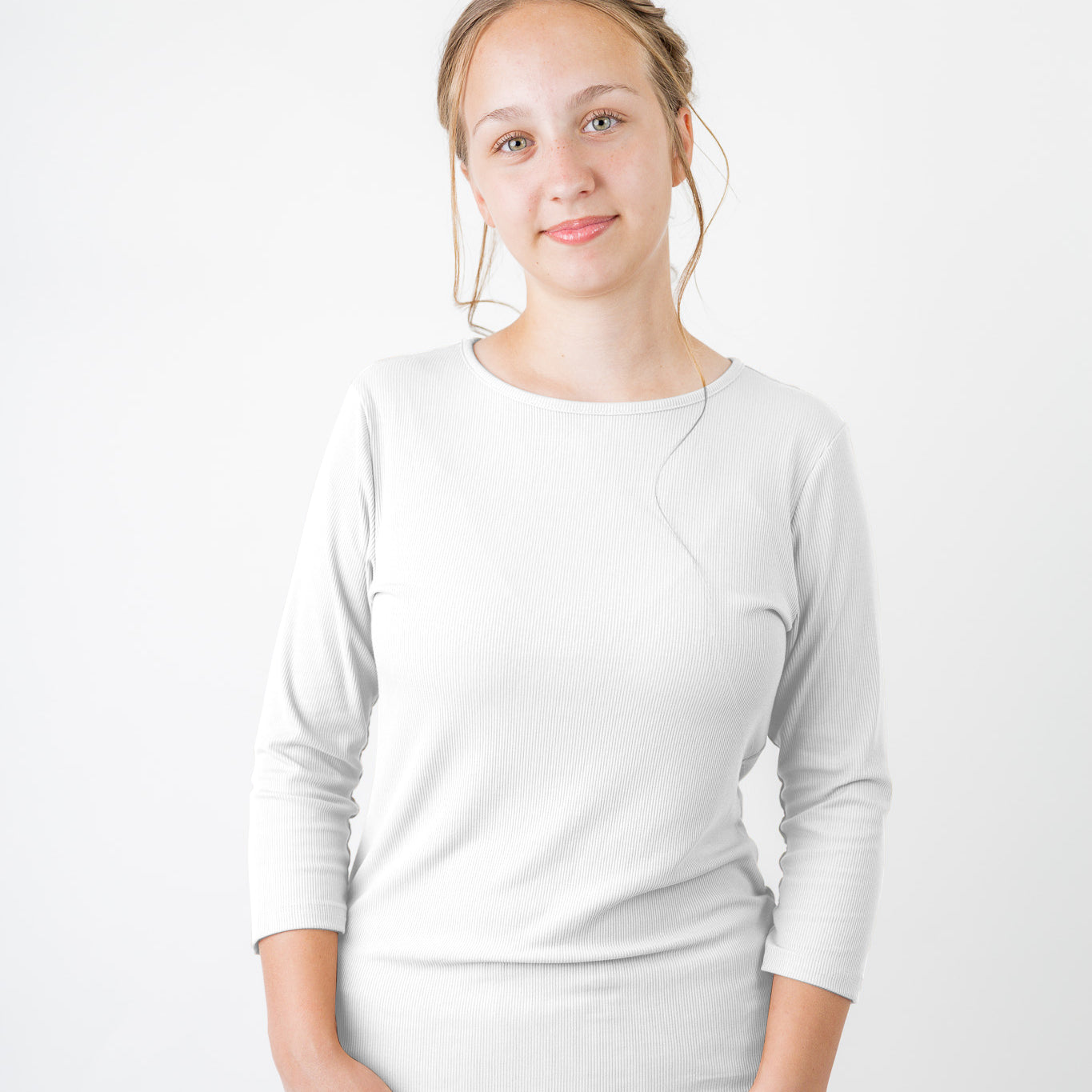 Model wearing the  Nuggles®  Essential 3/4 Tee in ribbed fabric, a modest, fitted top with 3/4 sleeves and a rounded neckline. Shown in a neutral tone, ideal for layering.