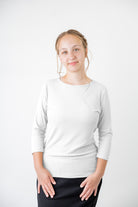 Model wearing the  Nuggles®  Essential 3/4 Tee in ribbed fabric, a modest, fitted top with 3/4 sleeves and a rounded neckline. Shown in a neutral tone, ideal for layering.