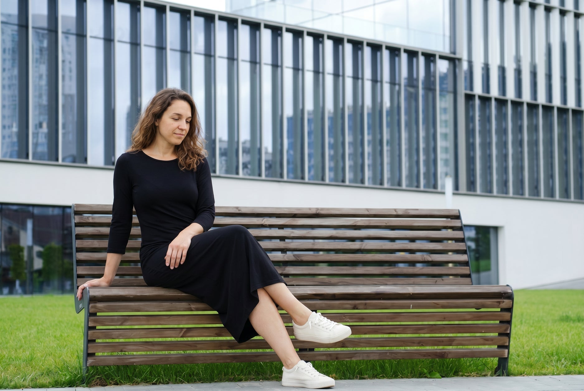 Woman wearing the Nuggles Original Midi Layering Dress in Black, a modest 46 inch cotton midi dress