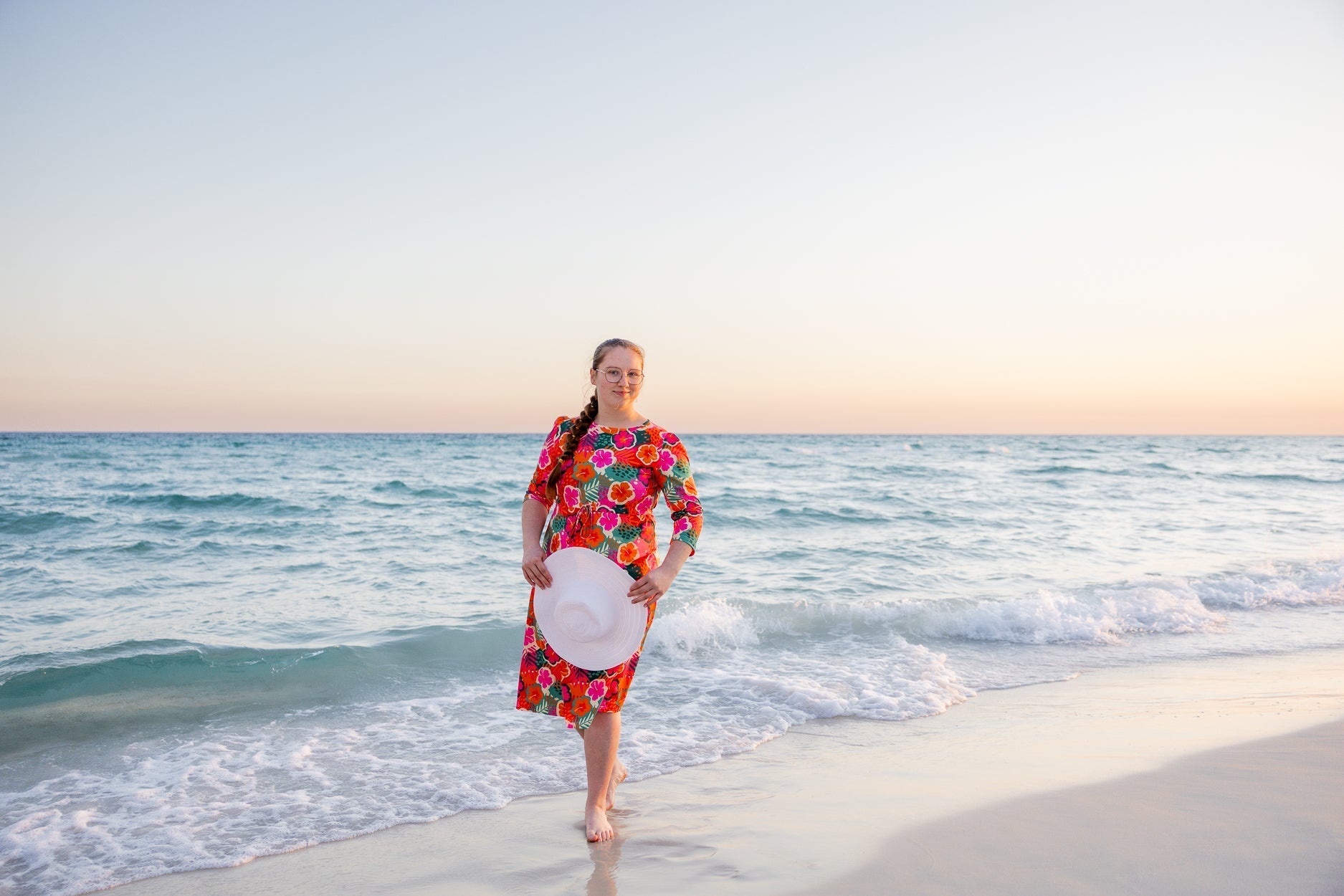 A women at the beach wearing a modest sport swim dress. 