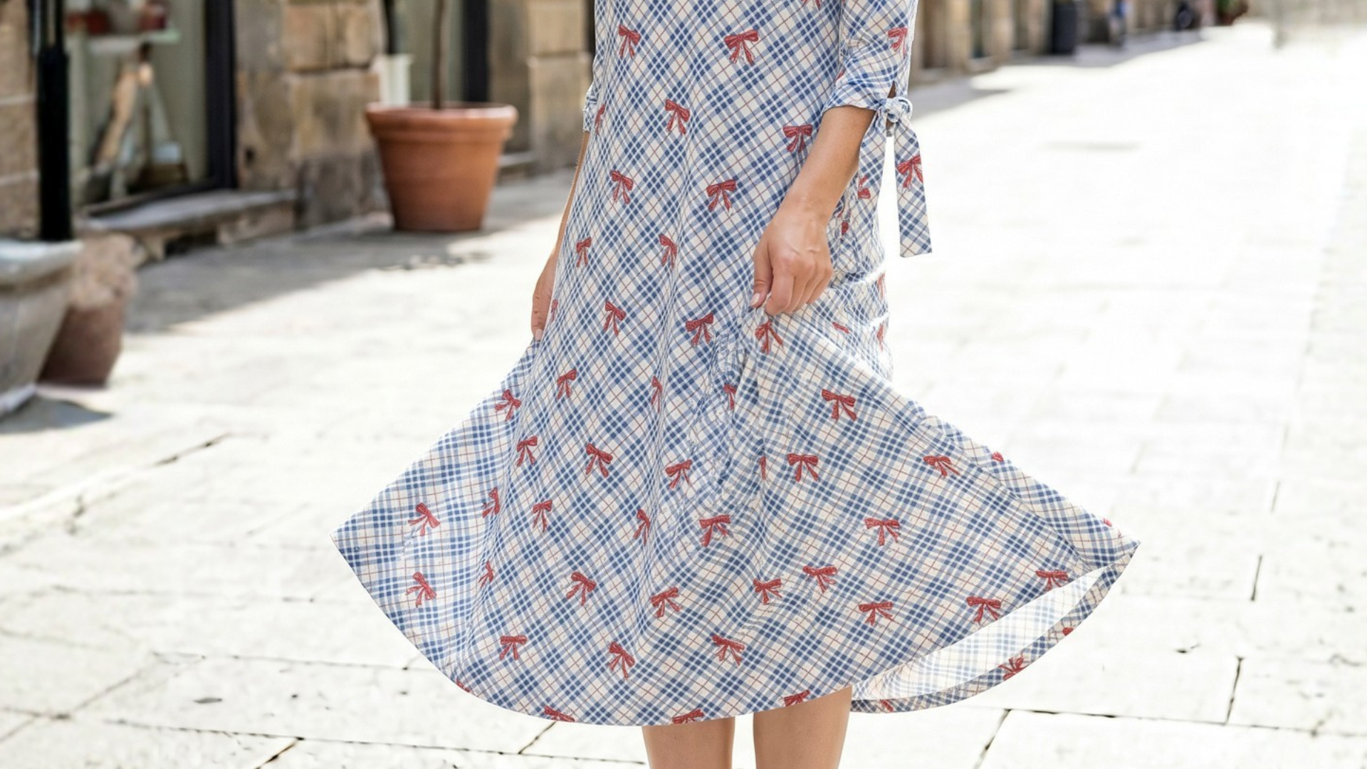 A picture of a women wearing a print dress from Nuggles. 