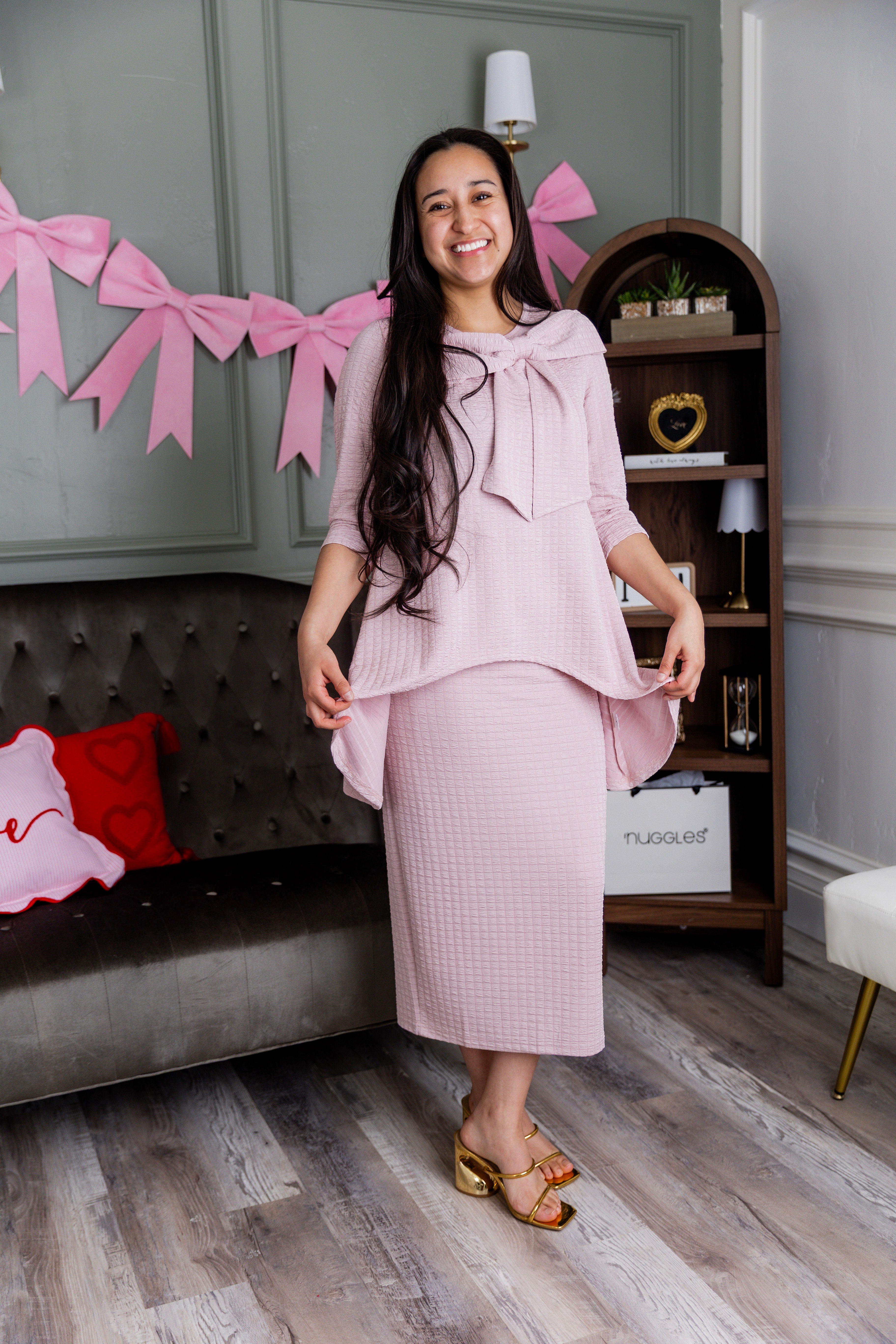 A model wearing our Eleanor top and skirt in pink. 