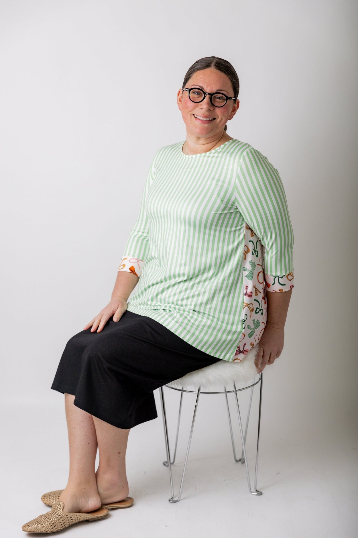 Women wearing a modest top and black pencil skirt from Nuggles that are available in plus sizes. 