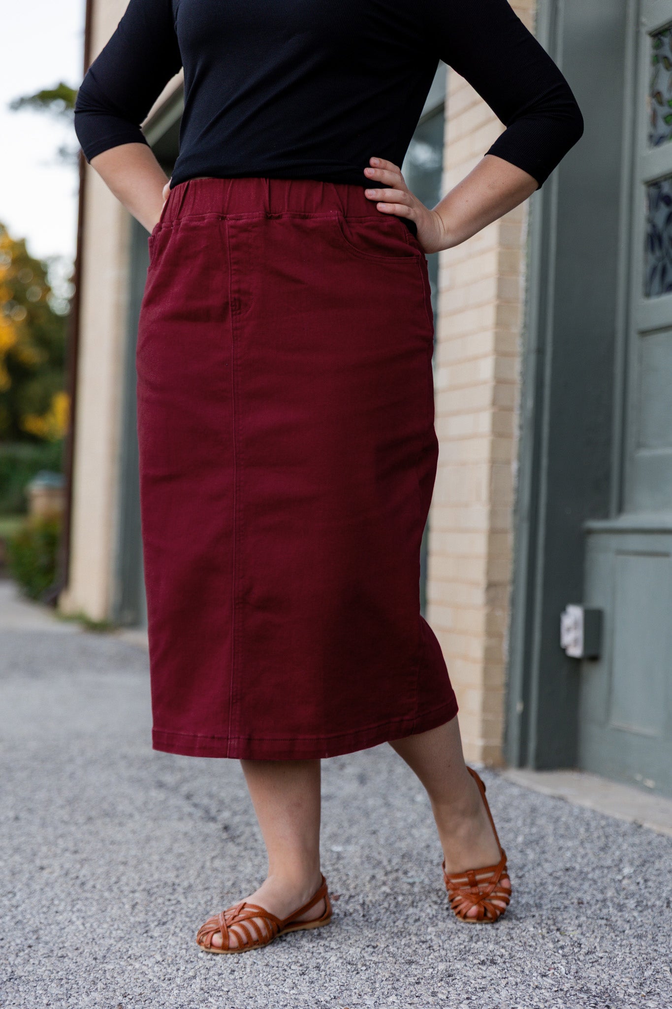 A women wearing a modest red midi skirt from Nuggles®