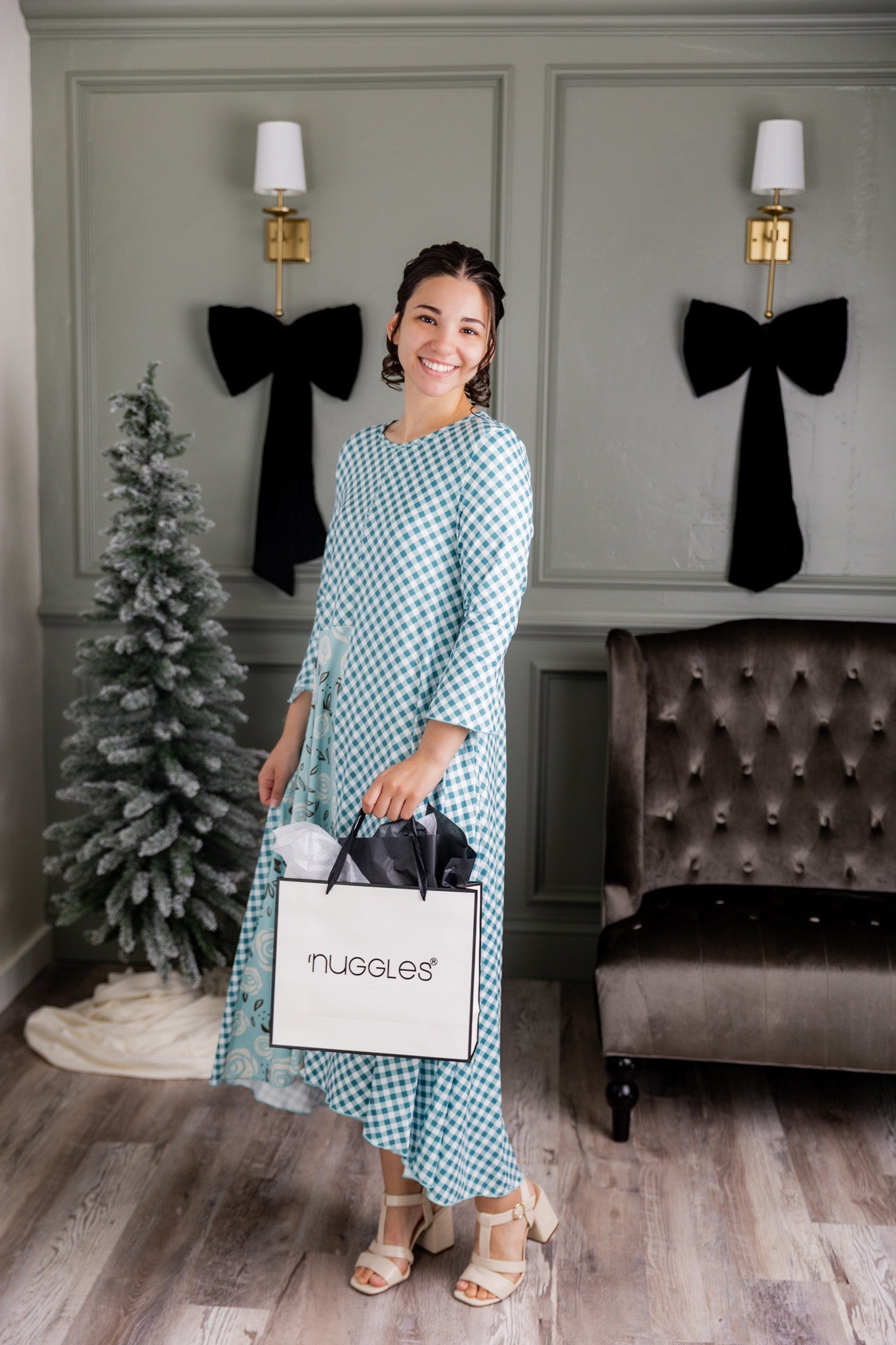 A Women holding a Nuggles® Shopping bag wearing a Nuggles® blue dress that is featured on the black friday sale list.