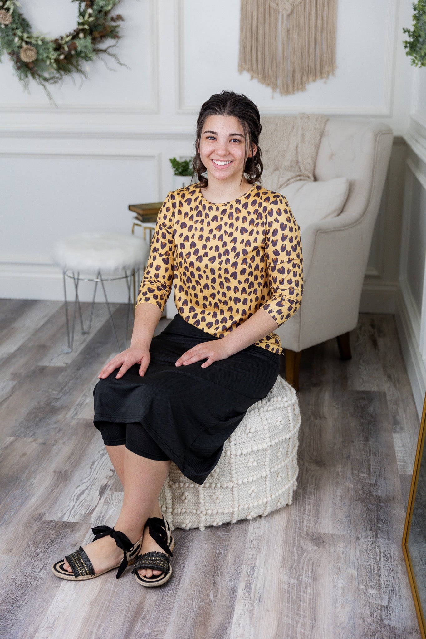 Woman wearing a leopard modest essential tee with an athletic skirt with attached leggings. Featuring some of the bestselling items on our website. 
