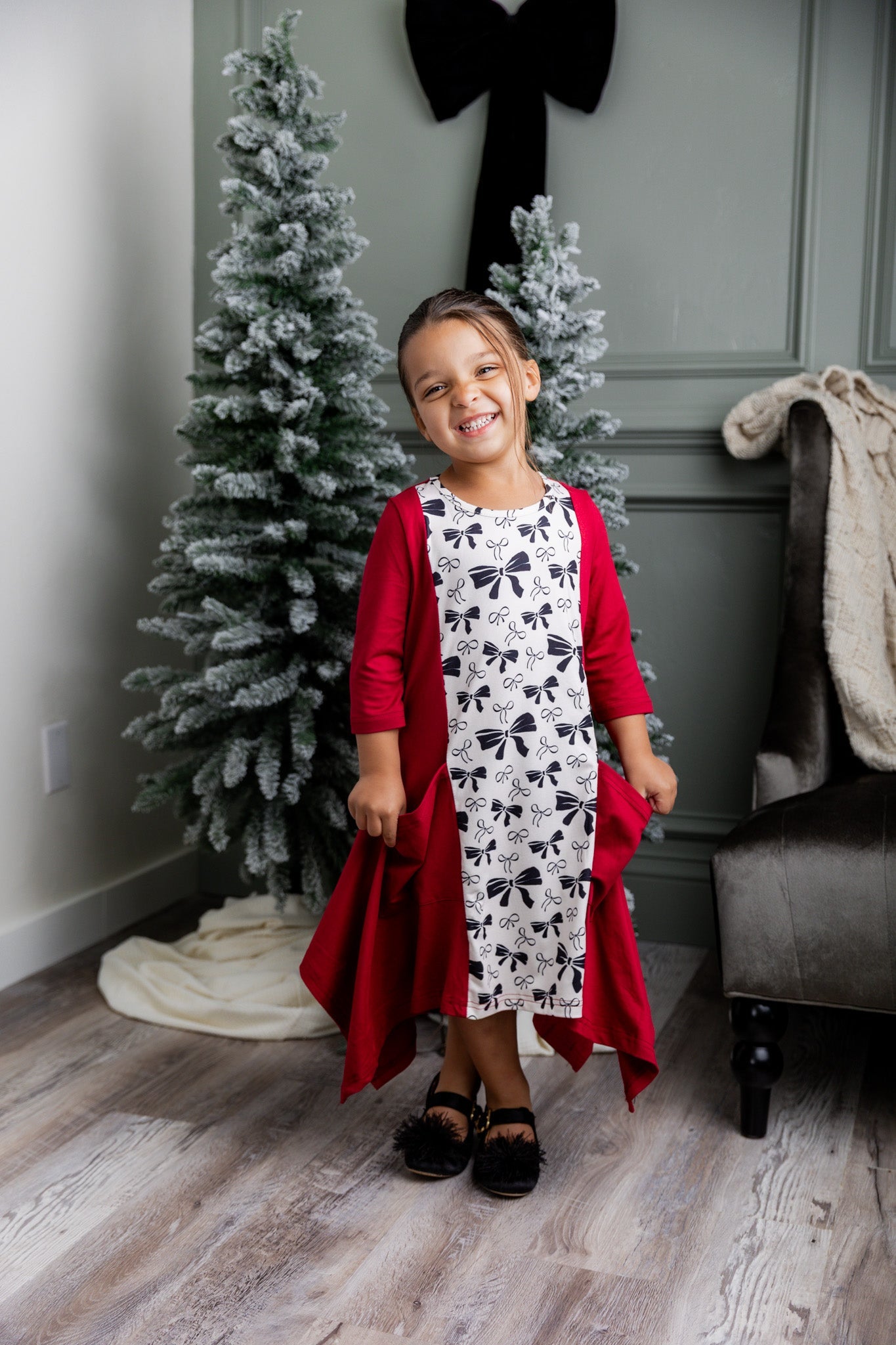 Modest Girls Clothing for sizes 4T to girls size 14. This is a model wearing Nuggles® Raegan Dress in Bow Belle.