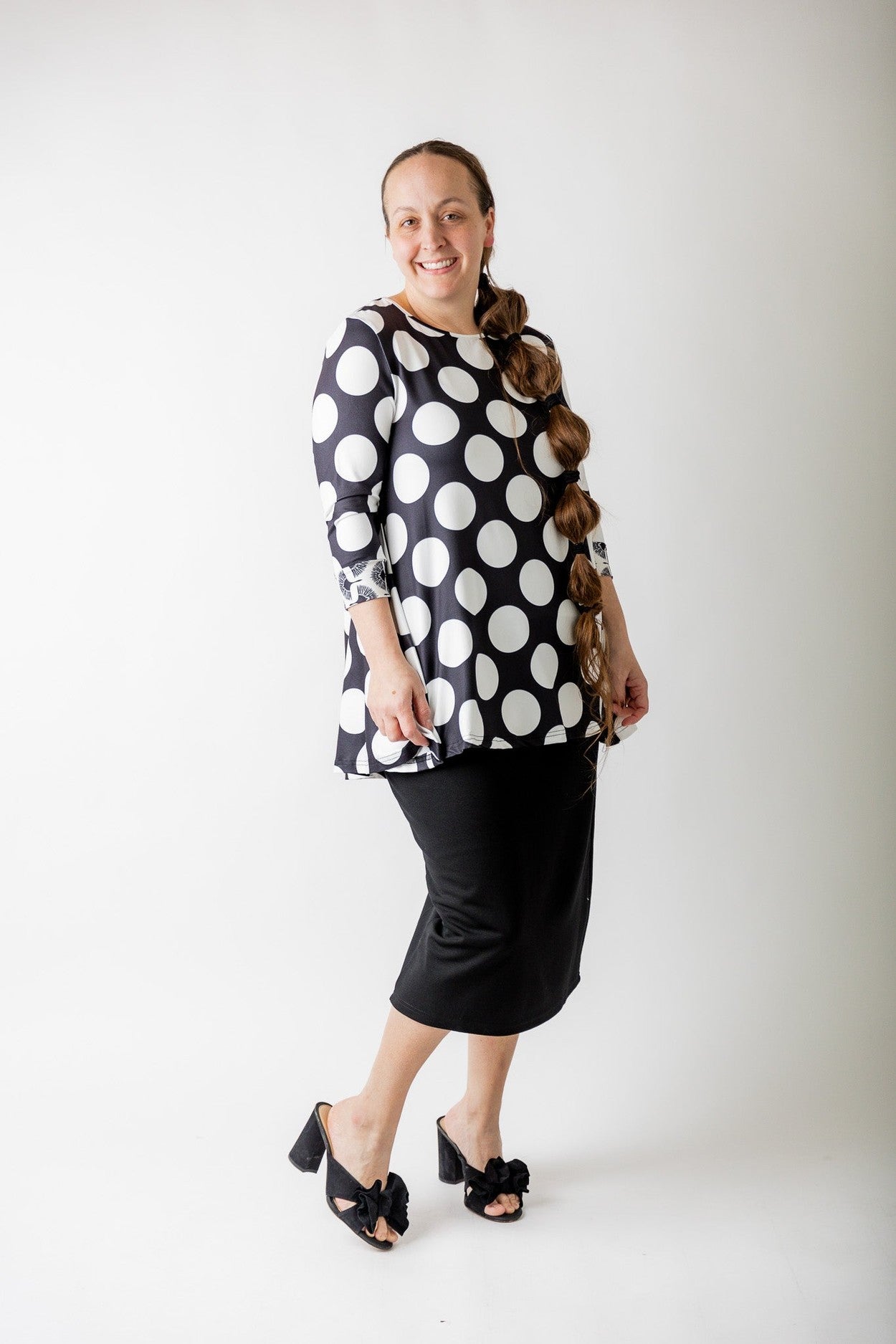 A woman wearing a modest top that is nursing friendly. 