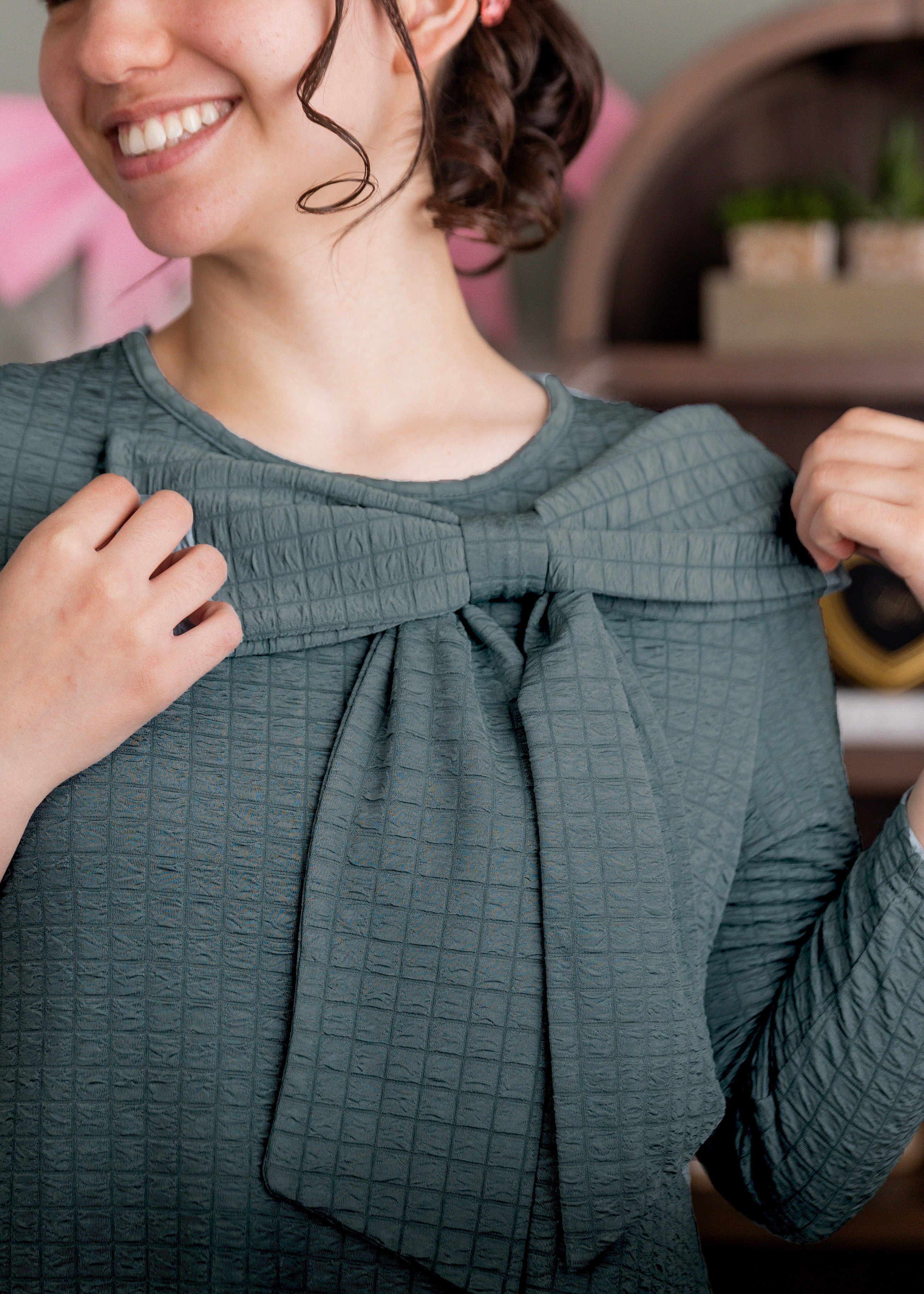 The Ladies Green Eleanor Top with a bow.