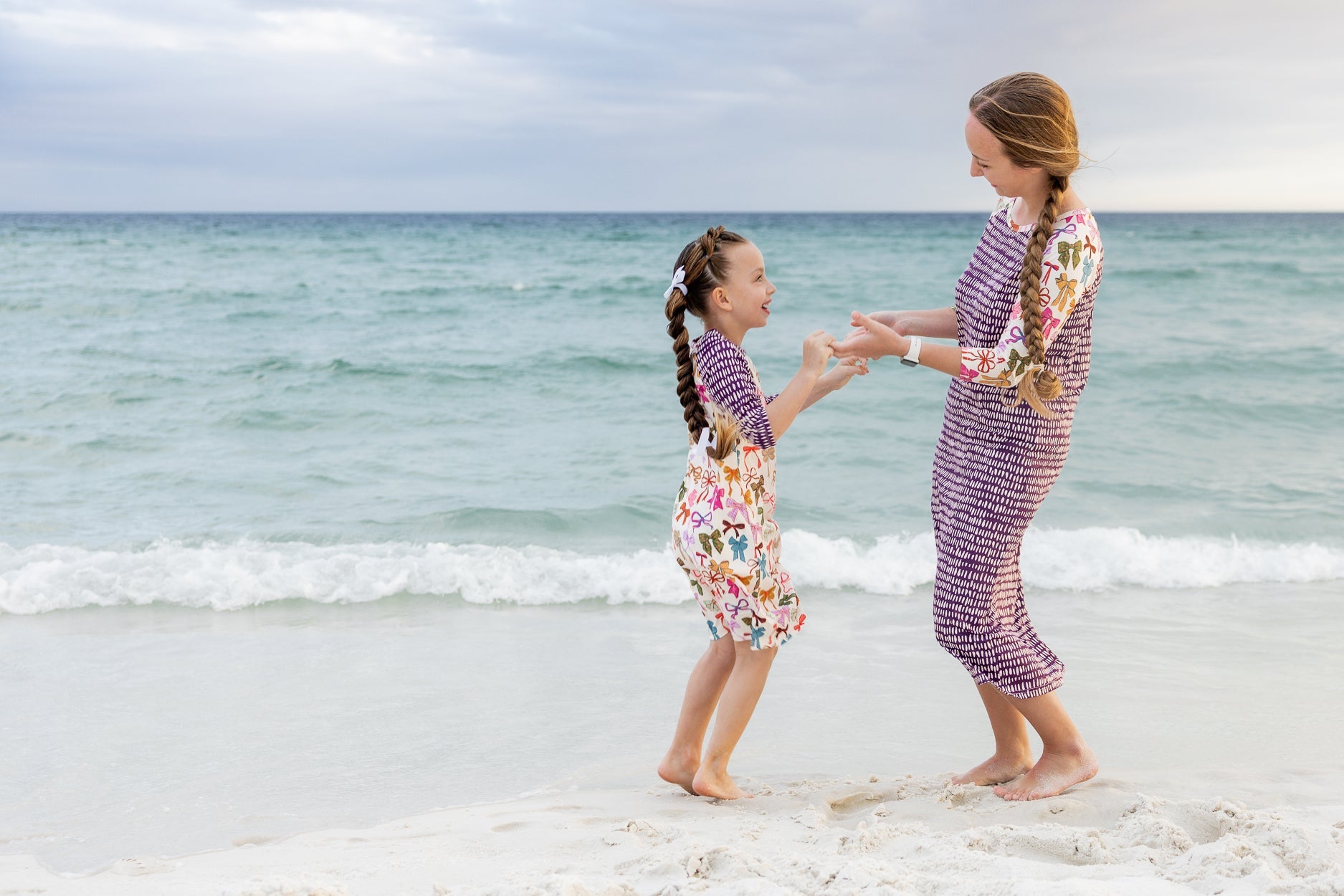 A girl and women wearing the first release of the swim collection. A modest dress style that has 3/4 sleeves and midi length. 