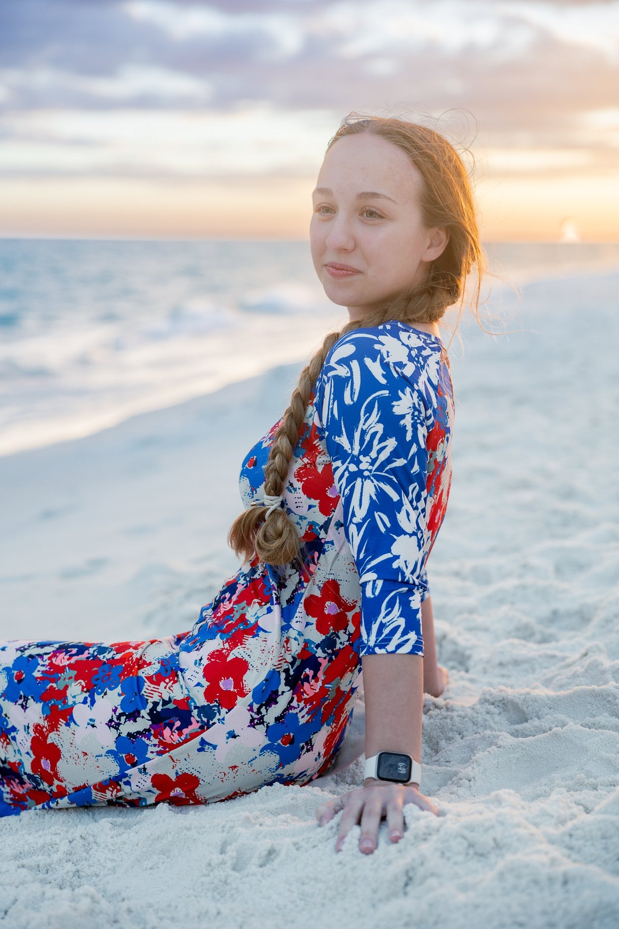 The Sport Swim Dress that is part of the Costal Refresh Swim Collection pictured on a beach.