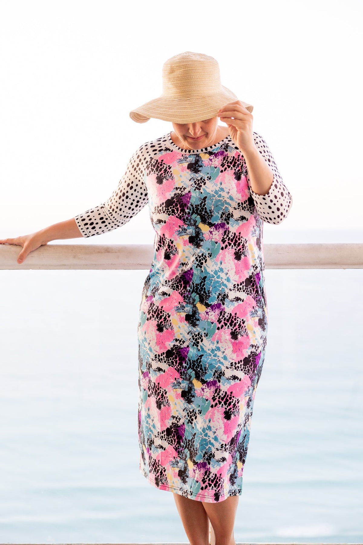 A dress from our Sunset Refresh Swim Dress Collection that features 3/4 length sleeves and a midi length dress.  