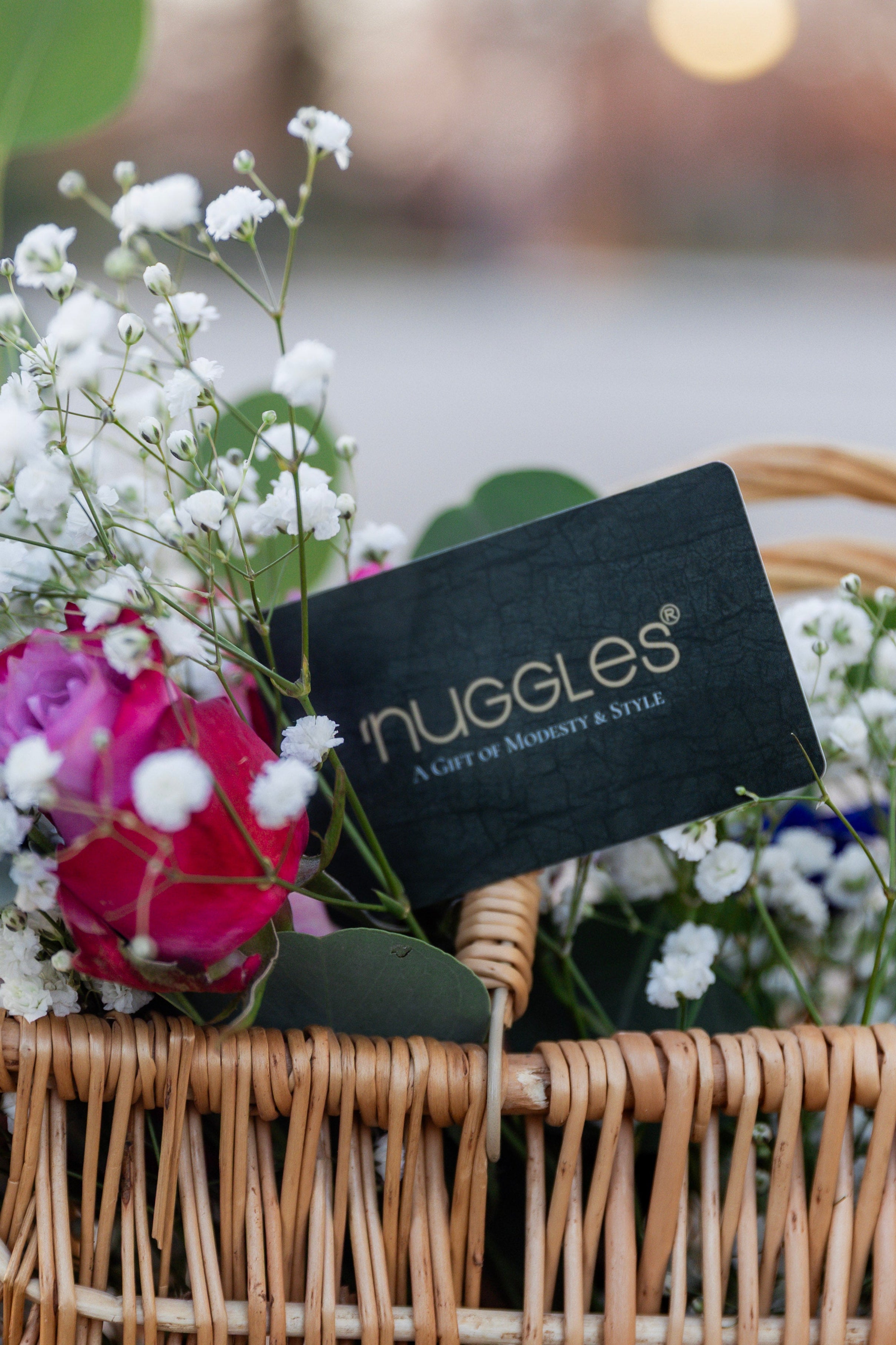 An image of the Nuggles® Gift Card surrounded by flowers