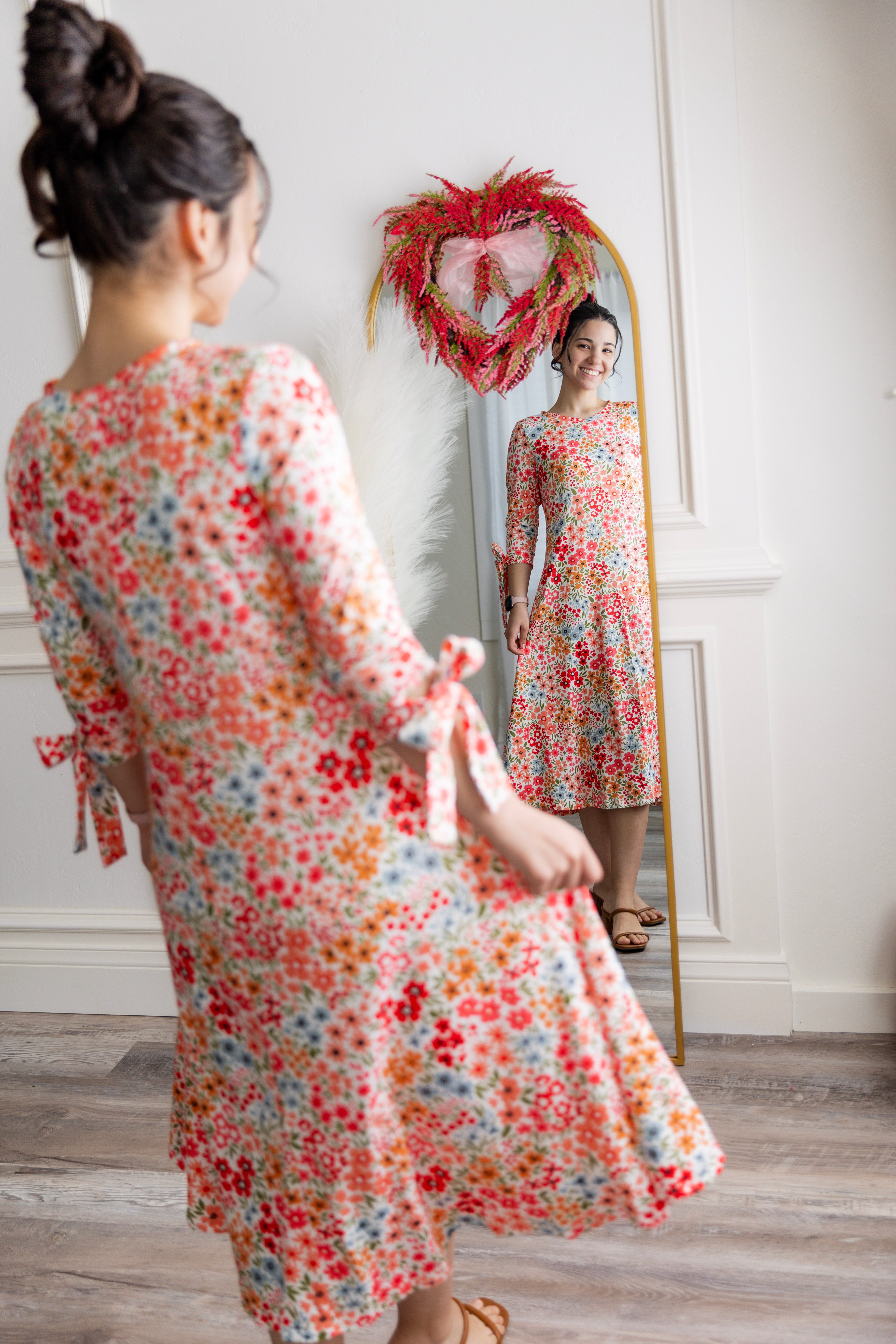 Model wearing the Nuggles® Hazel Dress in Confetti Garden Bloom floral print modest boutique dress