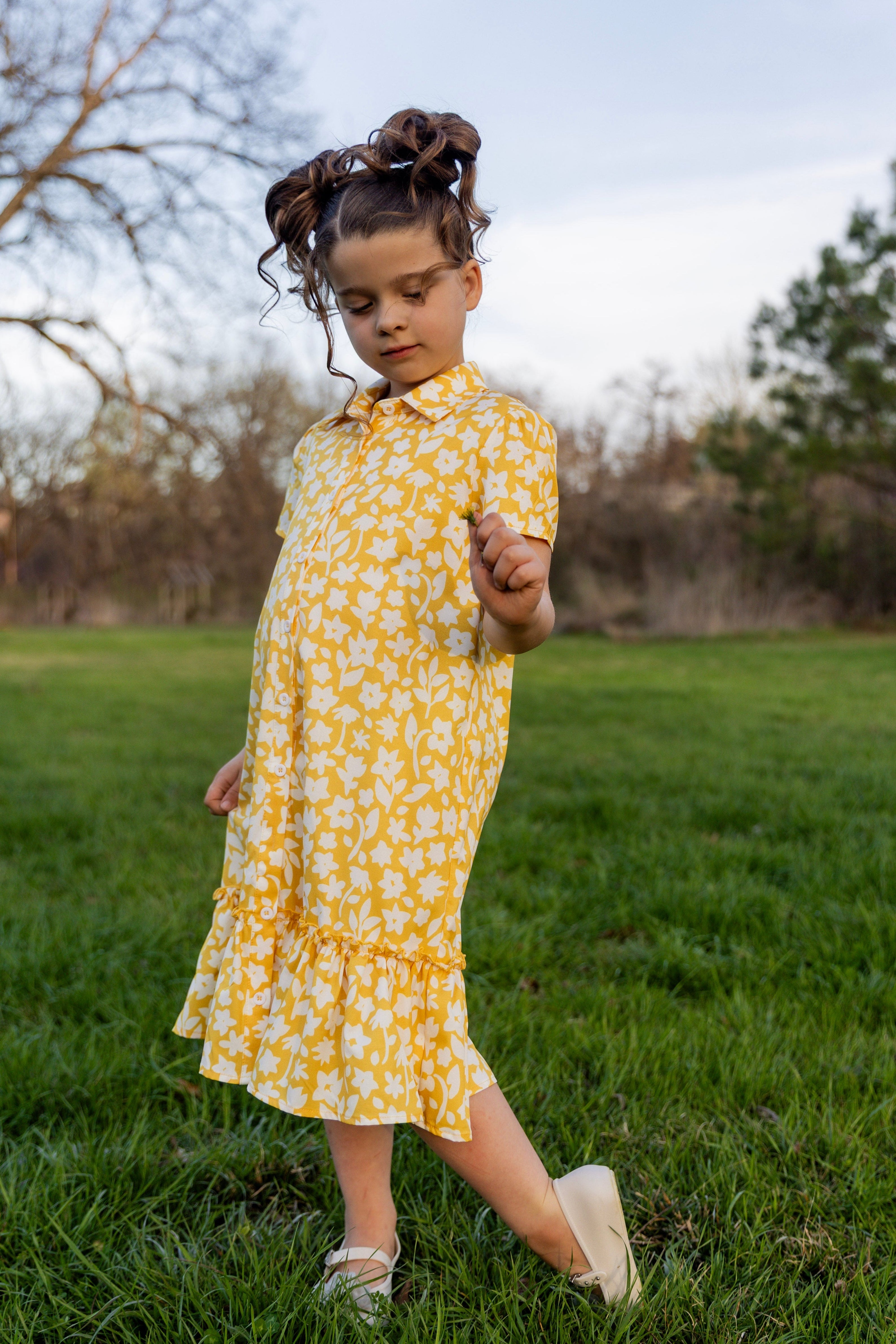 Model wearing Nuggles® Girls' Ellie Dress Dress in Sunshine Sprigs