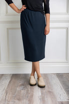 Model wearing a 27-inch classic lightweight midi skirt with an elastic waistband, styled modestly for everyday or church wear.