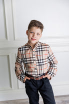 Model wearing Nuggles® Boys' Button Down Shirt Sand Plaid