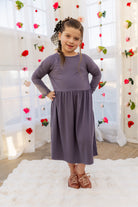Model wearing the Nuggles® Girls' Farah Dress in Purple