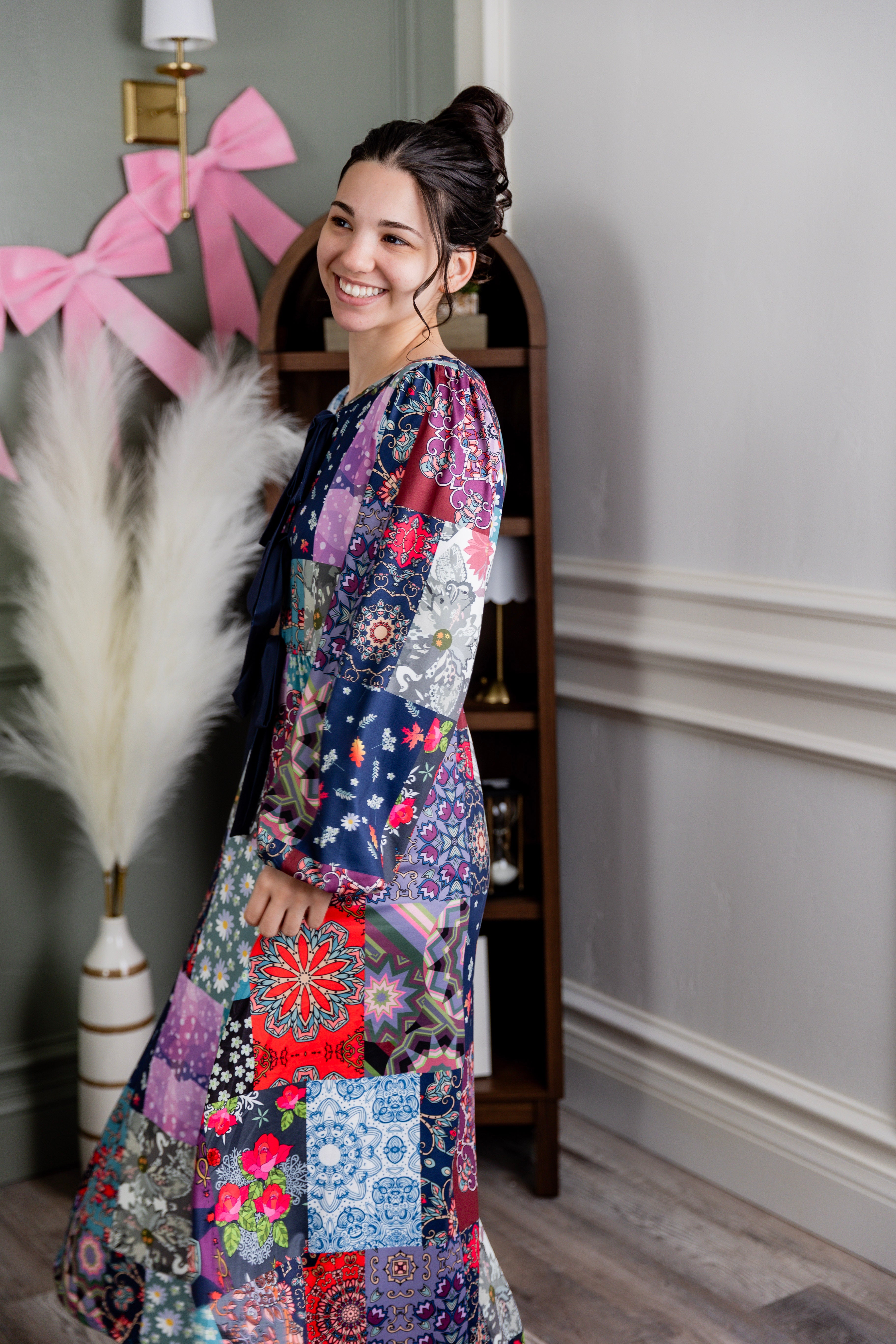 Model wearing the Nuggles® Addison Dress in Stitch & Sparkle