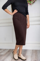 Model wearing a 27-inch classic lightweight midi skirt with an elastic waistband, styled modestly for everyday or church wear.