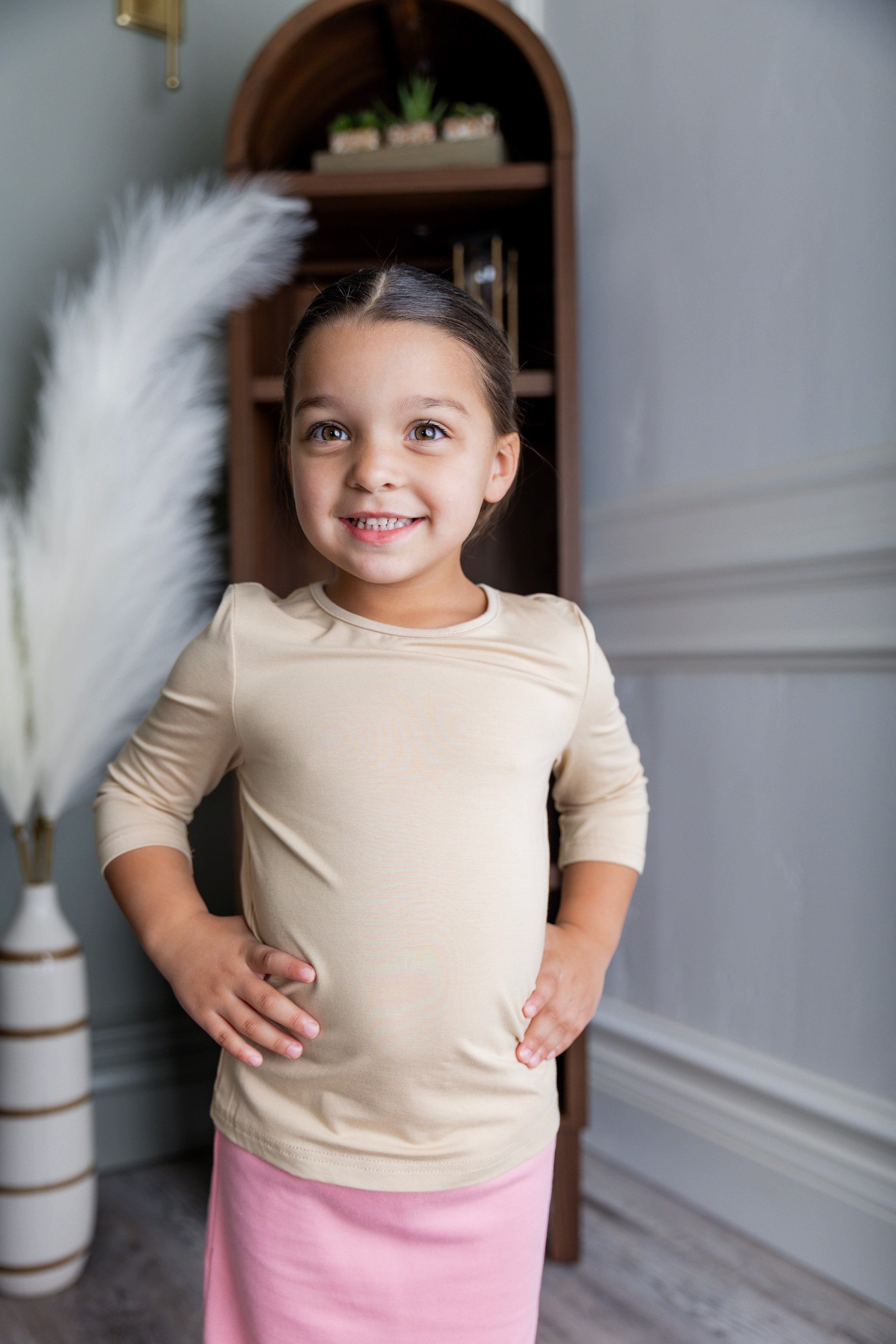 Model wearing our Nuggles® Girls Essential 3/4 sleeve tee.