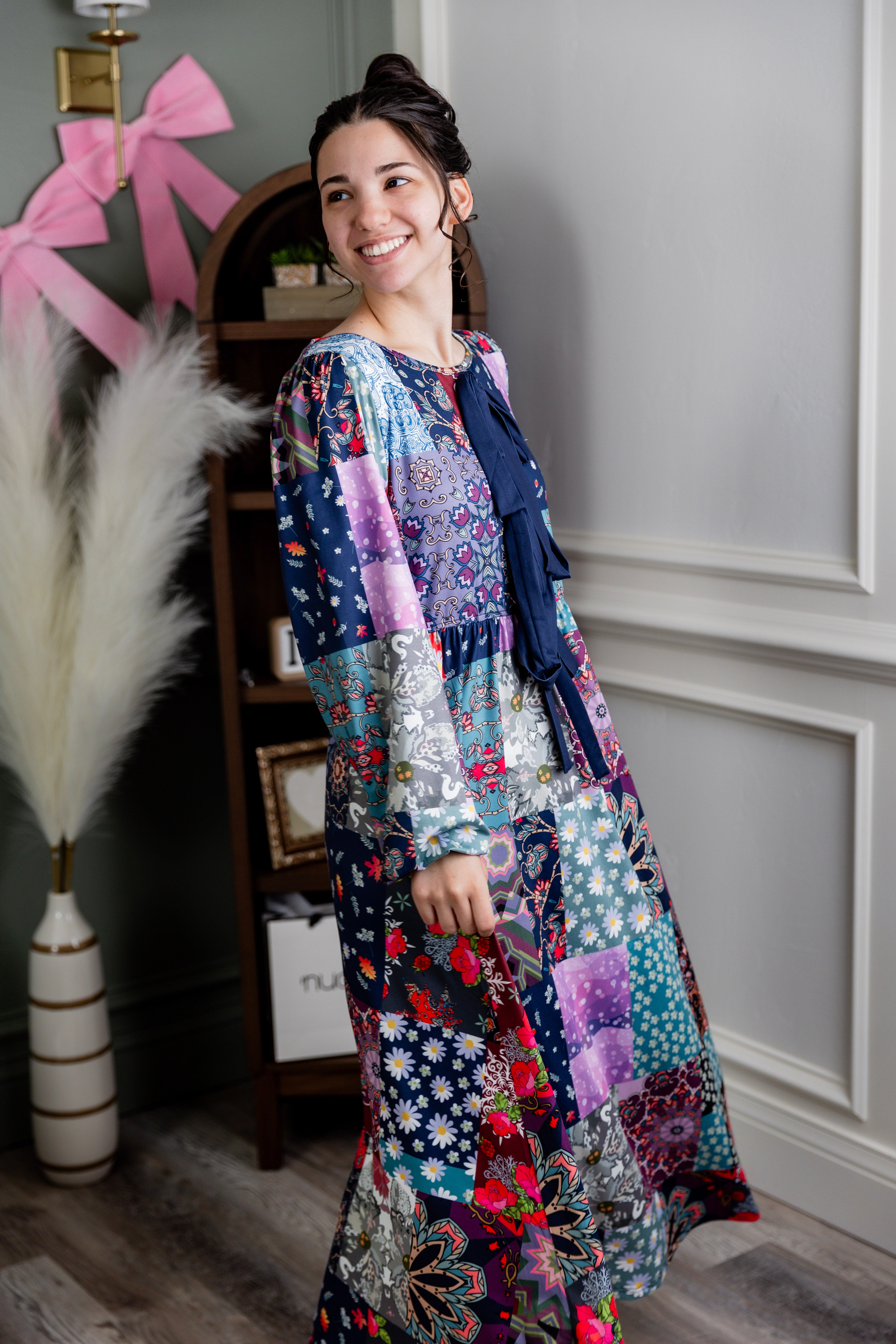 Model wearing the Nuggles® Addison Dress in Stitch & Sparkle