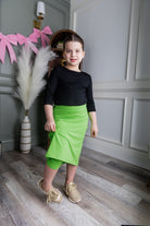 Model wearing Nuggles® Girls' All-Sport Skirt in Green