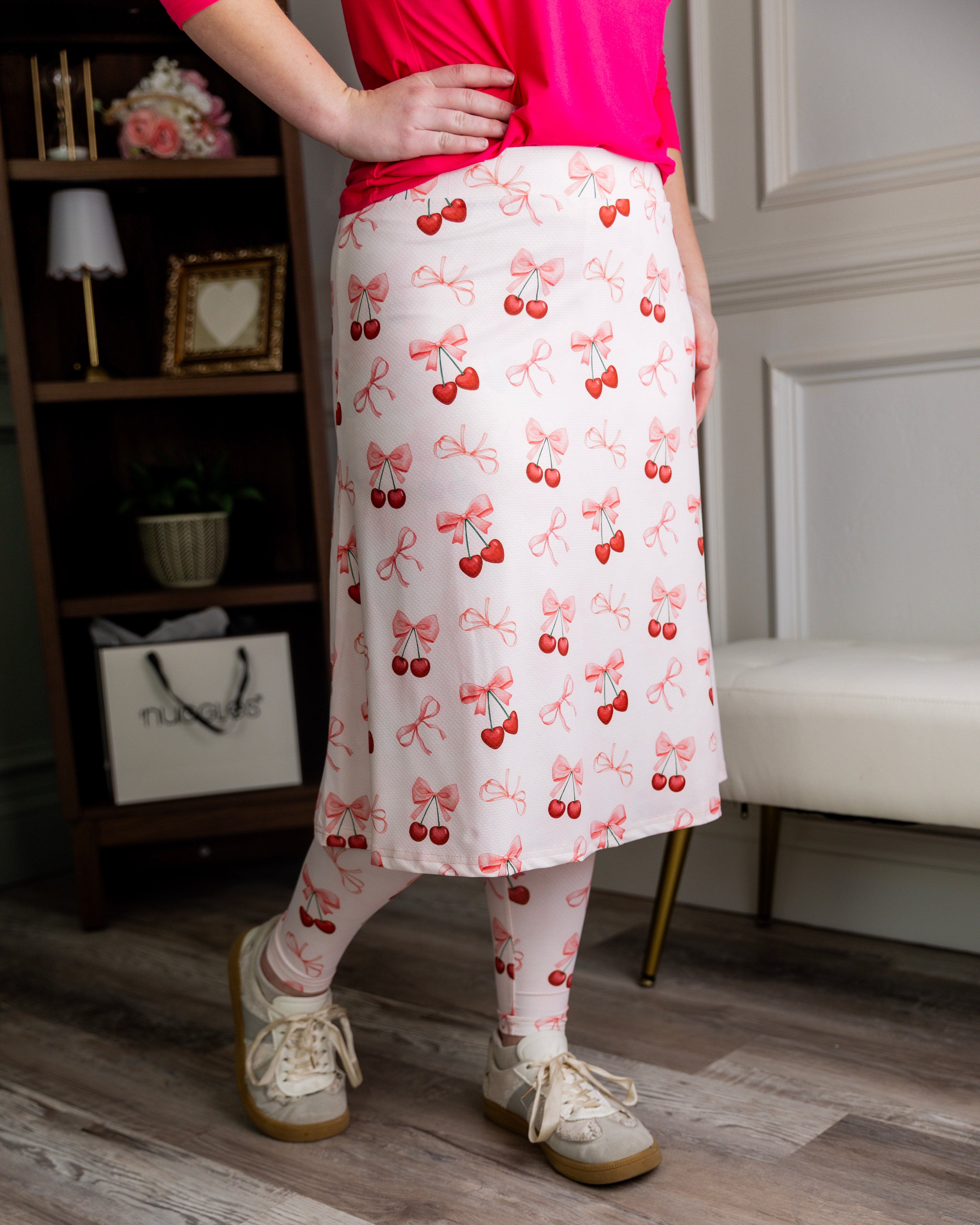 Model wearing Nuggles® Tilly Sport Skirt in Cherry Sweet