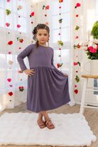 Model wearing the Nuggles® Girls' Farah Dress in Purple