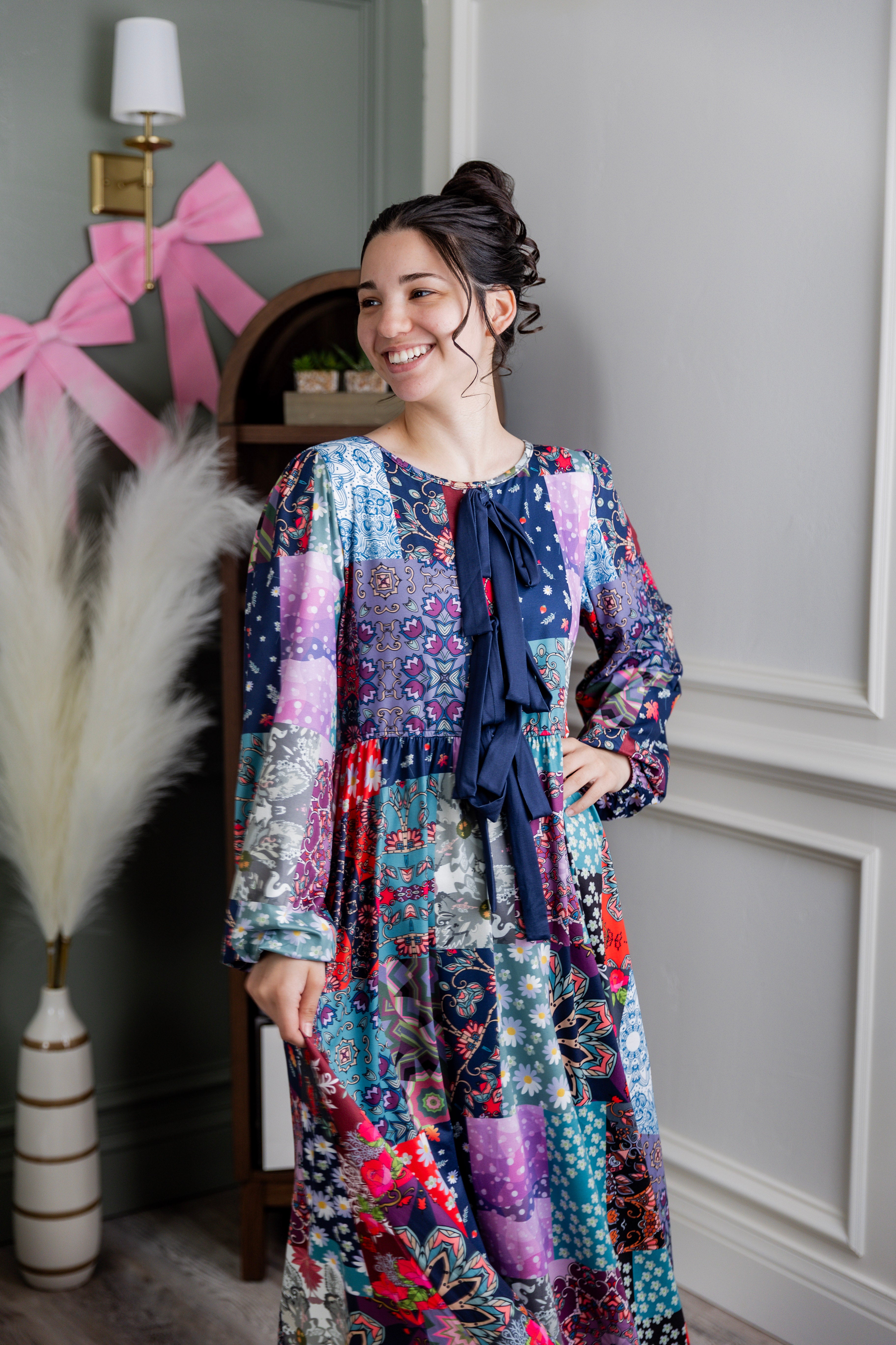 Model wearing the Nuggles® Addison Dress in Stitch & Sparkle