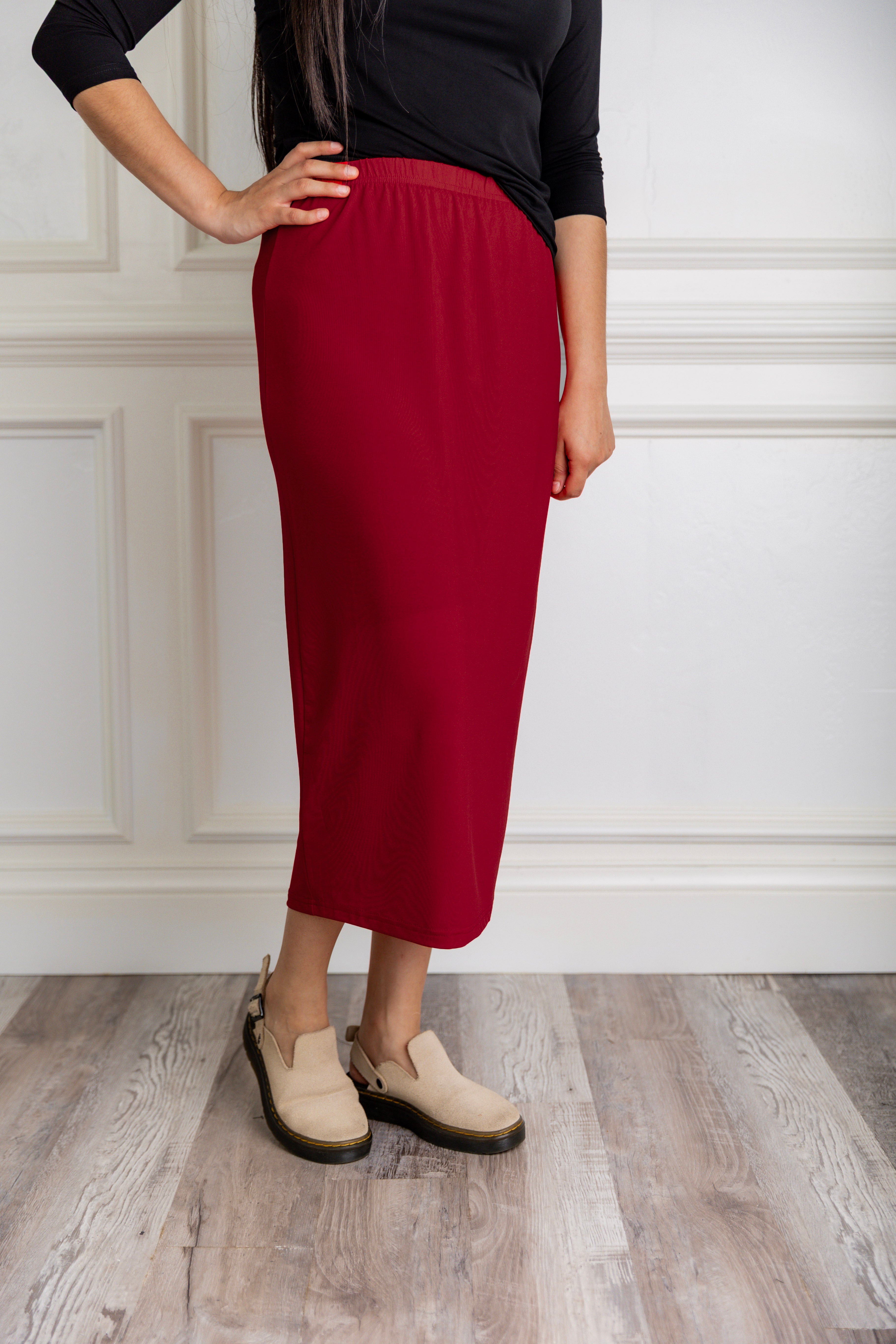Model wearing a 31-inch classic lightweight midi skirt with an elastic waistband, styled modestly for everyday or church wear.