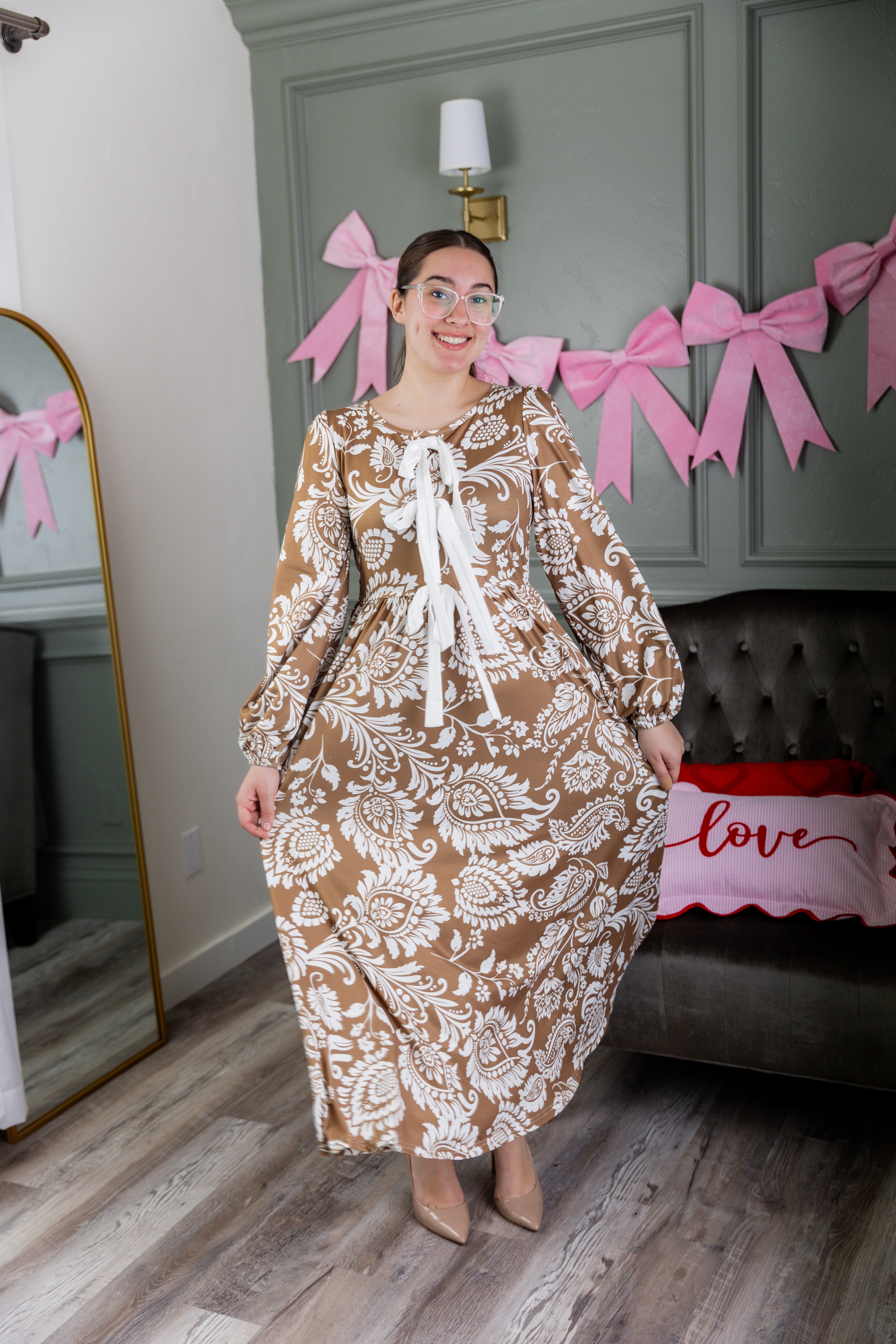 Model wearing the Nuggles® Addison Dress in Cinnamon Swirl Paisley