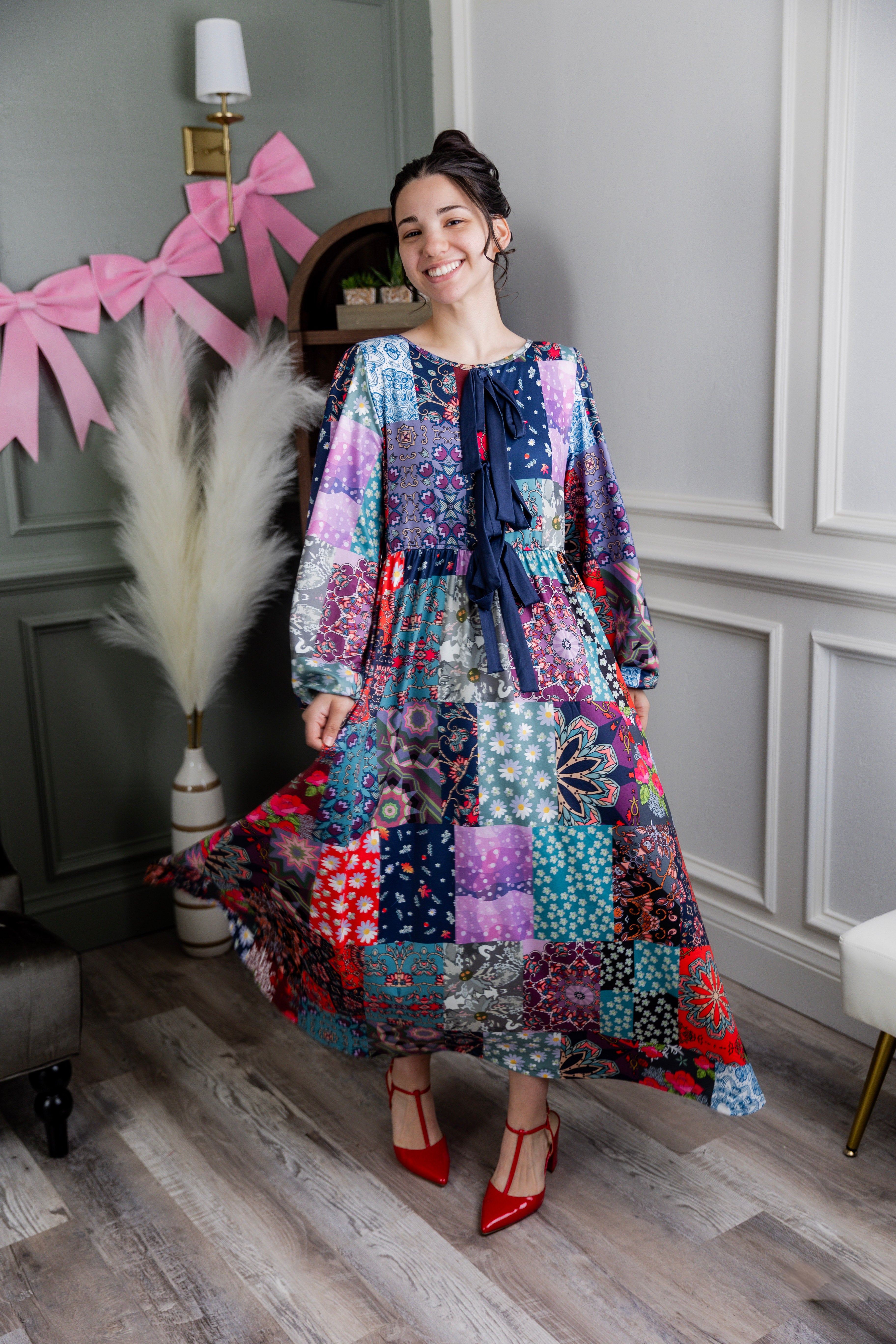 Model wearing the Nuggles® Addison Dress in Stitch & Sparkle