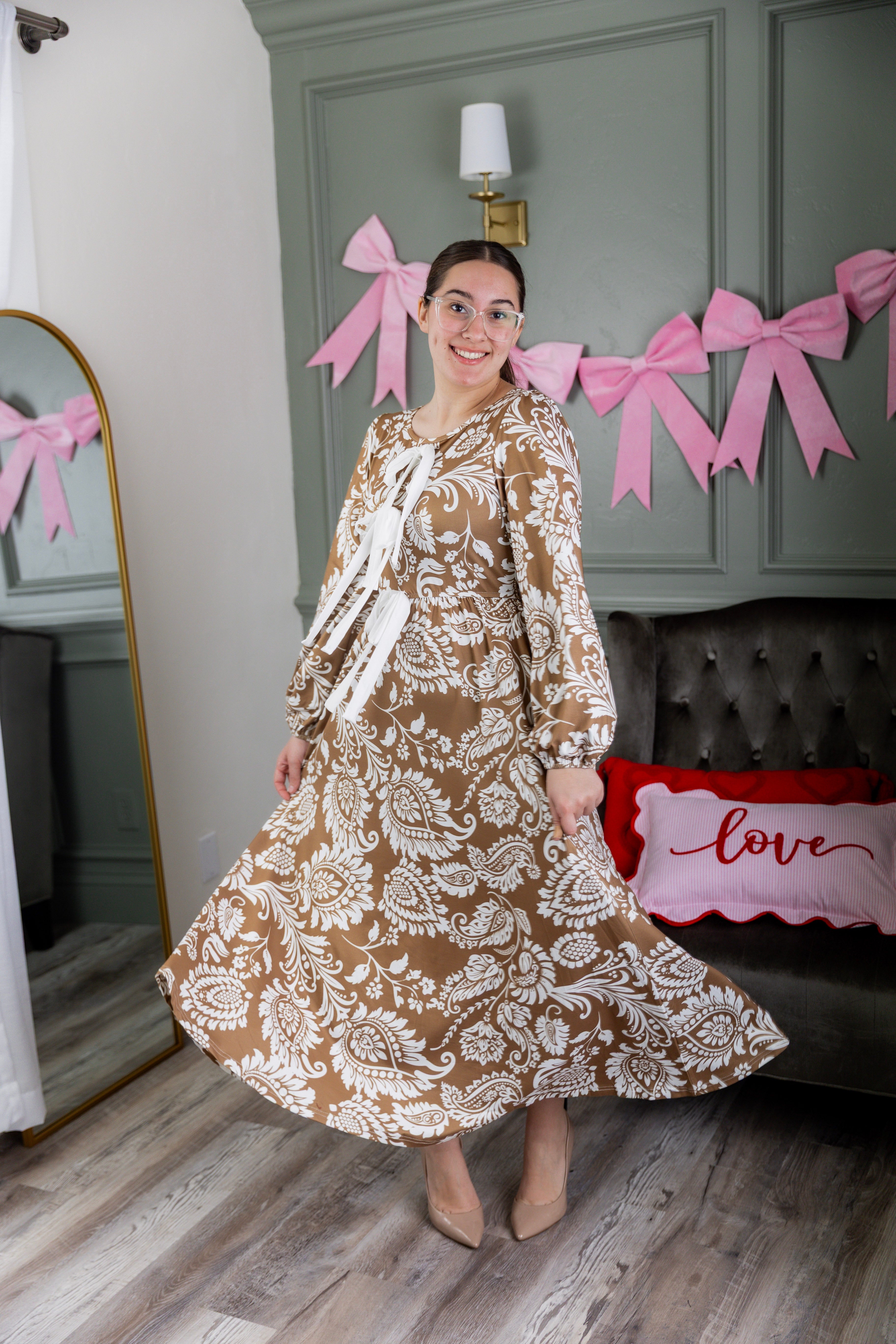 Model wearing the Nuggles® Addison Dress in Cinnamon Swirl Paisley