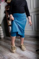 Model wearing Nuggles® Girls' All-Sport Skirt in Turquoise