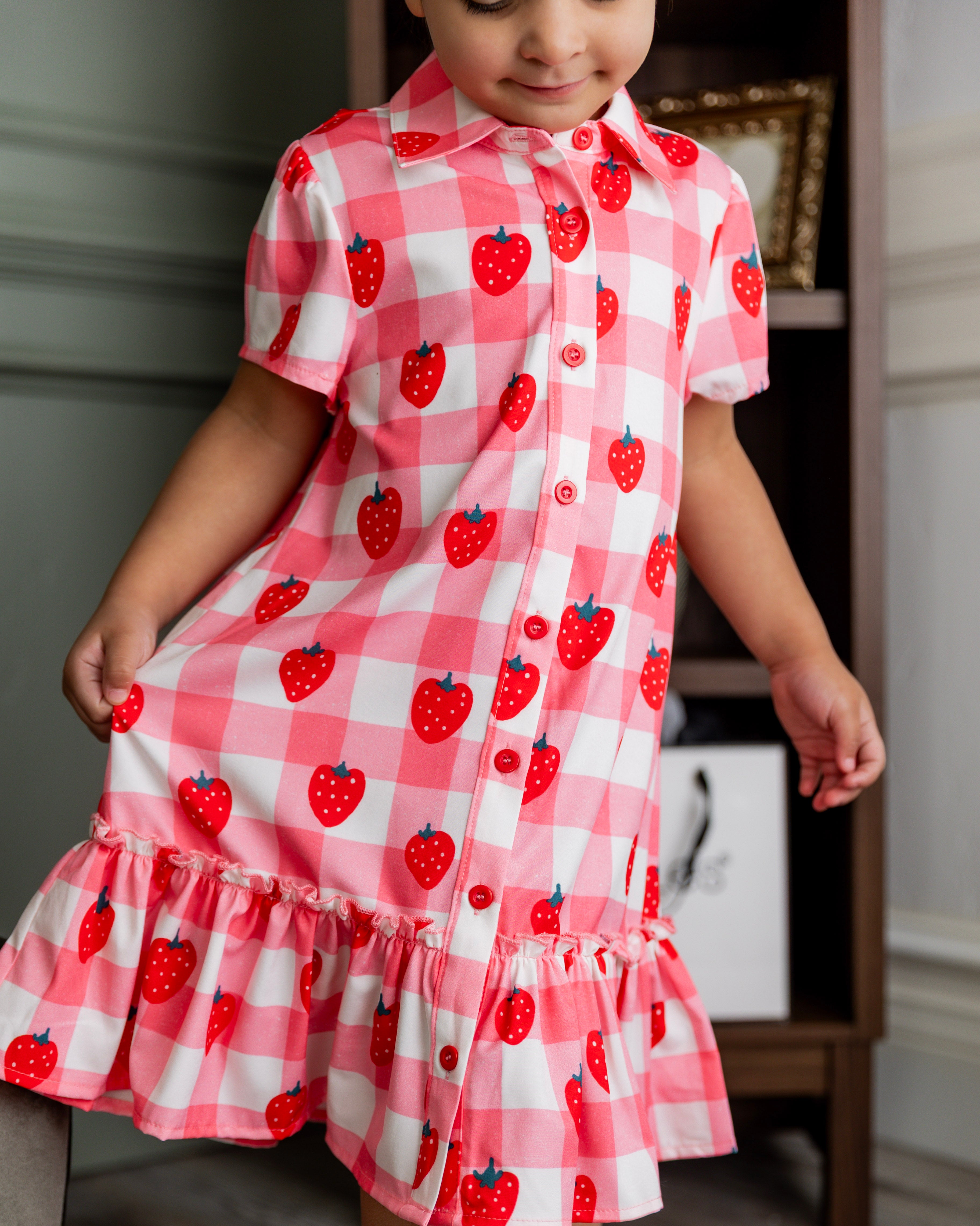 Model wearing Nuggles® Girls' Ellie Dress Dress in Strawberry Sweetheart