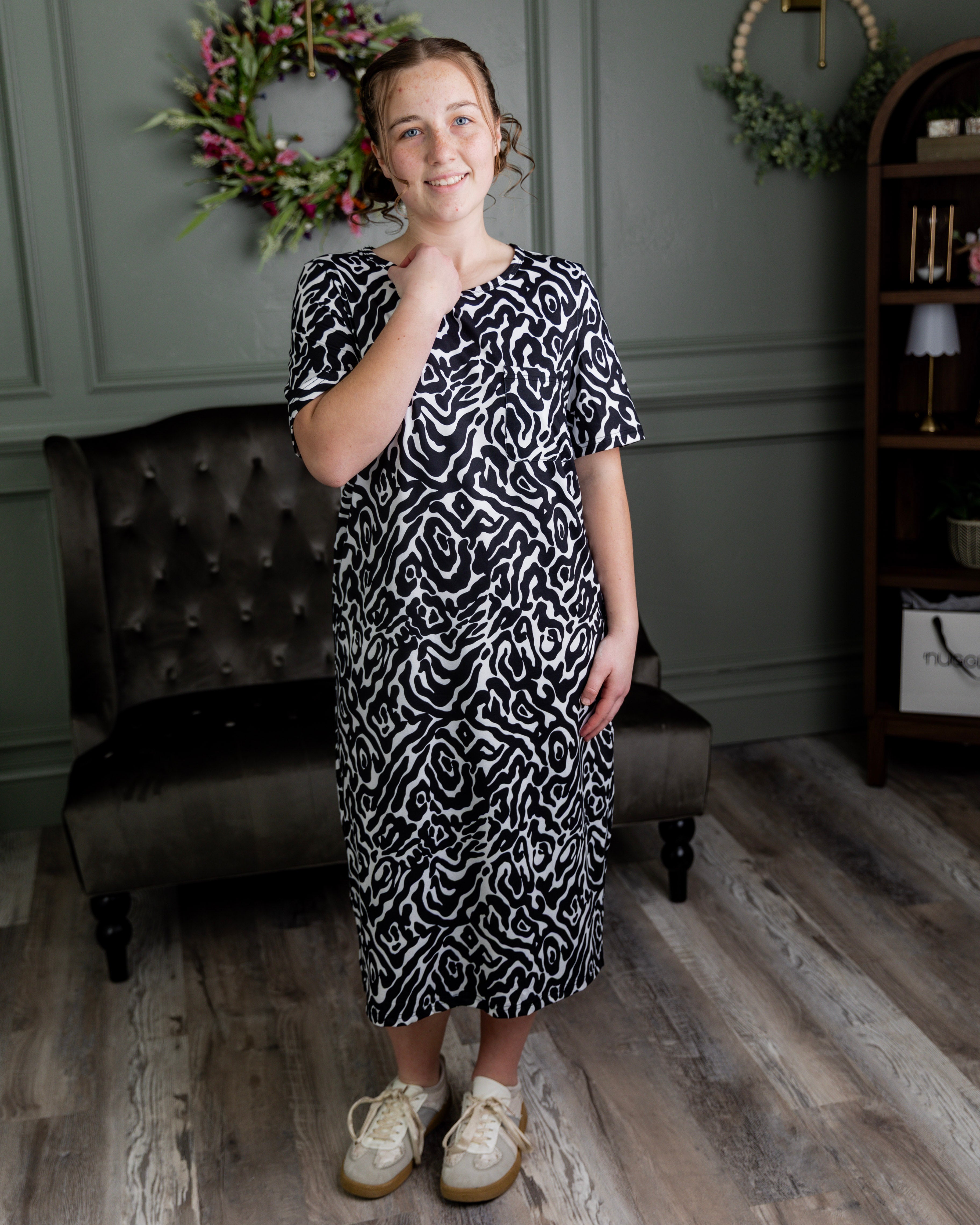 Model wearing Nuggles® Aviva Dress in Black Ink Bloom