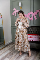 Model wearing the Nuggles® Addison Dress in Cinnamon Swirl Paisley