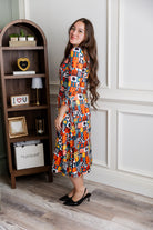 Model wearing Nuggles® Hazel Dress in Playful Patchwork print with bow-tie sleeves