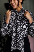 Model wearing Nuggles® Felicity top with large bow tie neckline, modest women's blouse.