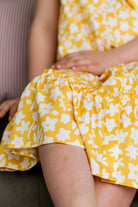 Model wearing Nuggles® Girls' Ellie Dress Dress in Sunshine Sprigs